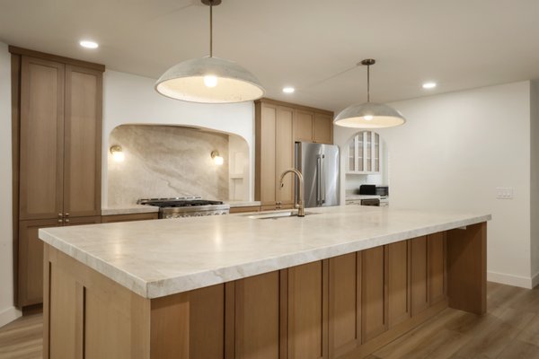 Kitchen Remodel Organic Luxury - This project was all about removing barriers. The original footprint was segmented and dark, blocking flow between the kitchen and living areas. Our goal was to create a seamless, airy open layout that didn't sacrifice storage or utility.