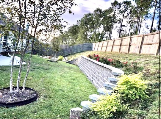Retaining Wall and Landscape - The retaining wall is to help with flooding and to add property value.