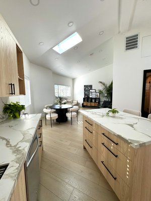 ADU Design & Build - This beautifully designed ADU showcases our signature blend of functionality, warmth, and modern elegance. Featuring an open-concept layout with soaring ceilings and a large skylight, the space is filled with natural light, creating an airy and inviting atmosphere.
The kitchen is thoughtfully designed with custom light wood cabinetry, sleek black hardware, and premium quartz countertops, all fabricated through our in-house stone expertise. A spacious island offers both storage and seating, making it perfect for everyday living and entertaining.
The living and dining area flows seamlessly, highlighted by clean lines, soft neutral tones, and carefully selected finishes that create a calm, cohesive look. Wide-plank flooring throughout adds warmth and continuity to the space.
Every detail in this ADU was carefully planned to maximize space, comfort, and style — from smart storage solutions to a layout that feels open yet functional. ADU Design & Build - This beautifully designed ADU showcases our signature blend of functionality, warmth, and modern elegance. Featuring an open-concept layout with soaring ceilings and a large skylight, the space is filled with natural light, creating an airy and inviting atmosphere.
The kitchen is thoughtfully designed with custom light wood cabinetry, sleek black hardware, and premium quartz countertops, all fabricated through our in-house stone expertise. A spacious island offers both storage and seating, making it perfect for everyday living and entertaining.
The living and dining area flows seamlessly, highlighted by clean lines, soft neutral tones, and carefully selected finishes that create a calm, cohesive look. Wide-plank flooring throughout adds warmth and continuity to the space.
Every detail in this ADU was carefully planned to maximize space, comfort, and style — from smart storage solutions to a layout that feels open yet functional.
