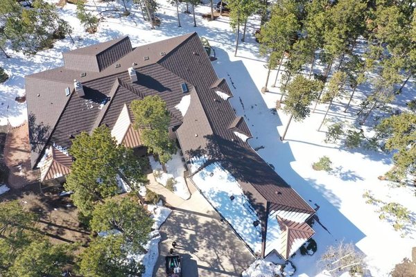 Roser Stone Coated Steel - A presidential shingle previously installed.  A Roser Stone Coated Steel installation with 24 gauge standing seam metal accent dormers in patina copper penny.