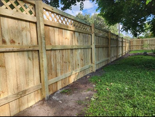 5+1 Board on Board with Lattice Top - This was a custom built 5' tall board on board style fence with added 1' tall lattice top for a 6' tall wood fence. This fence is built out of ground contact pressure treated pine. We screw in the rails to the post and use galvanized ring shank nails for the pickets into the rails.