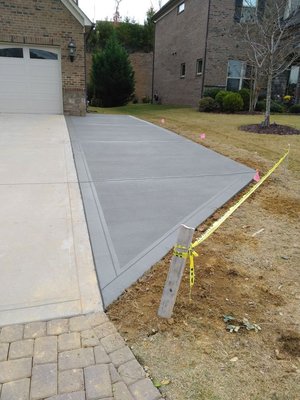 Driveway addition - This customer needed more parking spaces. Their family is growing and more of their kids are getting license and they need the parking room. We excavated the desired area for parking and poured them a new concrete parking area.