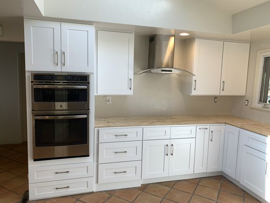 Palos verdes White shaker kitchen cabinets - This project was done in Palos Verdes, CA in 2023.
Amazing people glad they came out happy. They had a countertop guy so for this project we were only hired for cabinet installation as they already had someone for the countertops they were getting. This beautiful kitchen comes packed with accessories. First let’s start with the lazy Susan in the corner. An all time favorite cabinet for our customers. Next to the lazy Susan heading towards the cook too area to the left is a spice rack cabinet. Underneath the cooktop area there are two pull out drawers for pots and pans. We were also able to make the drawers above the door be fully functional as the drawers just barely missed the cooktops depth. Then we go to the eye grabbing double oven with two drawers under and doors over. Now we head to the right side of the kitchen and there is the dishwasher after that there is what we call a blind corner cabinet that reaches into the otherwise dead space. After that we have a double bin trash container at a perfect distance from the sink area. Now we head to the big pantry’s with multiple pull out drawers for easy access the all ingredients that she had perfectly organized. Then to top off the whole kitchen we have a double sided island. On the inside there is two cabinets with a wine cooler in the middle and on the outside we have two bigger drawer base cabinets. One of the drawers is the recharge station with and outlet installed into the back portion of the drawer so they can have phones and other devices charging up out of sight if the island top. This project was very fun to make come to life the customer was very excited and we made sure to make her happy and have everything the way she needed for it to be fully functional and inclusive to the ideas she had in mind. So glad to say this was a successful project! Palos verdes White shaker kitchen cabinets - This project was done in Palos Verdes, CA in 2023.
Amazing people glad they came out happy. They had a countertop guy so for this project we were only hired for cabinet installation as they already had someone for the countertops they were getting. This beautiful kitchen comes packed with accessories. First let’s start with the lazy Susan in the corner. An all time favorite cabinet for our customers. Next to the lazy Susan heading towards the cook too area to the left is a spice rack cabinet. Underneath the cooktop area there are two pull out drawers for pots and pans. We were also able to make the drawers above the door be fully functional as the drawers just barely missed the cooktops depth. Then we go to the eye grabbing double oven with two drawers under and doors over. Now we head to the right side of the kitchen and there is the dishwasher after that there is what we call a blind corner cabinet that reaches into the otherwise dead space. After that we have a double bin trash container at a perfect distance from the sink area. Now we head to the big pantry’s with multiple pull out drawers for easy access the all ingredients that she had perfectly organized. Then to top off the whole kitchen we have a double sided island. On the inside there is two cabinets with a wine cooler in the middle and on the outside we have two bigger drawer base cabinets. One of the drawers is the recharge station with and outlet installed into the back portion of the drawer so they can have phones and other devices charging up out of sight if the island top. This project was very fun to make come to life the customer was very excited and we made sure to make her happy and have everything the way she needed for it to be fully functional and inclusive to the ideas she had in mind. So glad to say this was a successful project!