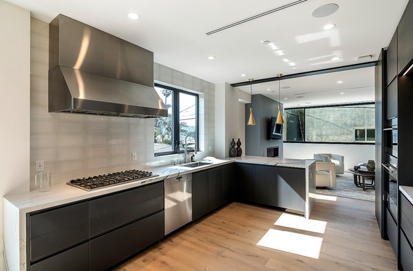 Kitchen Remodeling | Newport beach 2023 - We transformed this Newport Beach kitchen into a sleek, modern retreat with high-end commercial appliances and custom wood panel fronts that blend the fridge and freezer into the cabinetry for a refined, cohesive finish.
