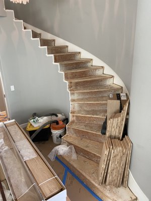 Engineered Hardwood Installation - This project was over 2,000 sqft of engineered oak install. Half of the floor was nailed to the plywood subfloor, the other half was glued over tile. The home featured a spiraled staircase.