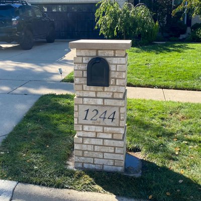Masonry Mailbox Rebuild, Redesign - The existing masonry mailbox with a brick arch was prone to freeze and thaw damage as there was no flashing system in place. The rebuilt design has a proper overhang and flashing underneath the limestone coping to prevent moisture buildup in the brick and mortar. The existing letterbox and stone address were salvaged for reuse on the new mailbox.