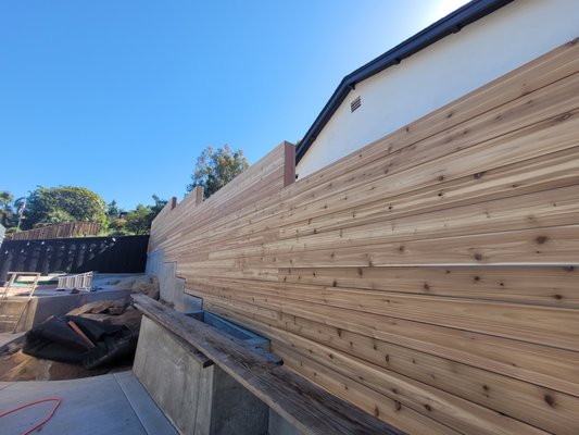 Tight knot cedar - We installed with steel post in concrete wall, flush to the face of the wall. Next picture is a deferent job, steel frame powder coated redwood roll gate w/operator. Tight knot cedar - We installed with steel post in concrete wall, flush to the face of the wall. Next picture is a deferent job, steel frame powder coated redwood roll gate w/operator.