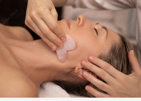 Facial Gua sha & Facial Cupping services - Blue Jade Wellness proudly offers Facial Gua Sha and Facial Cupping services, which are a natural alternative to cosmetic surgery or Botox. These modalities can gently improve blood circulation and lymph drainage to tone facial tissue, plump and tighten skin, soften expression lines and wrinkles, reduce puffiness, and reduce facial inflammation. It is extremely relaxing, effective, and leaves you looking and feeling noticeably firmer, radiant, and sculpted. 

Both Facial Gua Sha and Facial Cupping are safe, noninvasive, and do not leave marks on the face or require down time. Results are often seen immediately, and both services can be the perfect treatment for that special occasion. Stacy also partners closely with her clients to understand their goals, and with additional treatments, clients will see long lasting results.
Some of the benefits to Facial Gua Sha and Facial Cupping are: improves blood circulation, drains stagnant fluid and reduces inflammation, lifts sagging face muscles, relaxes tension in facial muscles, plumps wrinkles and facial lines, evens complexion and coloring, increases production of healthy collagen and elastin, reduces headaches and migraines, relieves sinus congestion, relaxes symptoms of TMJ (Temporomandibular Joint Dysfunction).

Give us a call today to schedule an appointment!