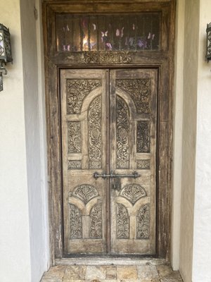Church Door - This is a north facing church door in Orlando which is weathered from rain, condensation and dirt build up.  
When it comes to exterior doors, many painters and other professionals do not understand the steps necessary for a long-lasting finish, nor do they understand why the finish is flaking off and/or blistering.   
We will remove the existing surface on the trim and install a temporary door to bring this door to our shop to work in a controlled environment.  Our process on a custom door will take a few weeks, but when complete will be guaranteed for 2 years.  Standard doors can be completed sooner and we support all door types.
We will post this completed custom job by January.