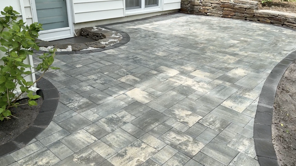 Patio Design - Fairfield, CT | Nicolock Oceanic Blue 3 Piece Paver | Charcoal 6x9 Boarder | Custom Rounded Bluestone Pad Door well with fieldstone step | Custom Curved 2 Level Fieldstone Wall | Crushed Marble Stepping Stone accent
Call now & Save up to $5000 summer! 959.229.7266