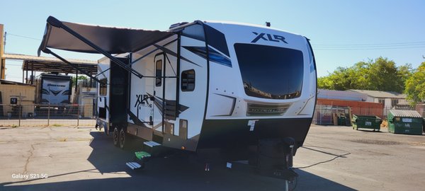 Why Rent a Toy Hauler!? - The Forest River XLR is ideal for renters who want the best of both worlds—an RV for family camping and a toy hauler for transporting recreational equipment. With its comfortable interior, ample sleeping areas, and versatile garage, it’s perfect for group trips, off-road adventures, or extended stays at campgrounds. Whether you’re heading to the mountains, desert, or a lakeside retreat, the XLR ensures you travel in style, comfort, and convenience.
Forest River is the perfect travel trailer for adventurers seeking both comfort and versatility. Designed with outdoor enthusiasts in mind, this toy hauler provides ample space to transport ATVs, motorcycles, bikes, or other outdoor gear while offering the conveniences of a modern RV. With stylish interiors, a spacious garage, and family-friendly features, the XLR Boost 3310 ensures renters have everything they need for a memorable trip.
Key Highlights & Features
Spacious Garage for Gear and Toys
• 10-foot garage area with easy-access ramp door for loading toys and gear.
• Tie-down points and non-slip flooring ensure safety and security while transporting heavy items.
• The garage converts into a living area or additional sleeping space with fold-down sofas and a queen-sized bed lift.
Comfortable Living Quarters
• Sleeps up to 6-8 people with a private master bedroom (queen bed), fold-down sofas, and electric bunk beds in the garage.
• A large slide-out expands the living area, creating more room to relax.
• Cozy entertainment center with a TV mount and speakers.
Modern Kitchen and Dining
• Fully equipped kitchen with a 3-burner stove, oven, microwave, and refrigerator.
• A spacious U-shaped dinette provides a comfortable place for meals or game nights.
• Plenty of storage cabinets for groceries and cooking essentials.
Bathroom Amenities
• Full bathroom with a walk-in shower, sink, toilet, and linen storage.
• Separate bathroom entrance from both the main area and the garage for added convenience.
Climate Control and Utility Features
• Air conditioning and heating for year-round comfort.
• Onboard generator (optional) to power the trailer off the grid.
• Power awning with LED lighting provides shade and outdoor space.
• Large freshwater, greywater, and blackwater tanks for extended stays.
Outdoor Living and Convenience
• Exterior fuel station to refill ATVs or motorcycles on the go.
• Exterior speakers and TV hookups for outdoor entertainment.
• Multiple storage compartments for camping gear and tools. Why Rent a Toy Hauler!? - The Forest River XLR is ideal for renters who want the best of both worlds—an RV for family camping and a toy hauler for transporting recreational equipment. With its comfortable interior, ample sleeping areas, and versatile garage, it’s perfect for group trips, off-road adventures, or extended stays at campgrounds. Whether you’re heading to the mountains, desert, or a lakeside retreat, the XLR ensures you travel in style, comfort, and convenience.
Forest River is the perfect travel trailer for adventurers seeking both comfort and versatility. Designed with outdoor enthusiasts in mind, this toy hauler provides ample space to transport ATVs, motorcycles, bikes, or other outdoor gear while offering the conveniences of a modern RV. With stylish interiors, a spacious garage, and family-friendly features, the XLR Boost 3310 ensures renters have everything they need for a memorable trip.
Key Highlights & Features
Spacious Garage for Gear and Toys
• 10-foot garage area with easy-access ramp door for loading toys and gear.
• Tie-down points and non-slip flooring ensure safety and security while transporting heavy items.
• The garage converts into a living area or additional sleeping space with fold-down sofas and a queen-sized bed lift.
Comfortable Living Quarters
• Sleeps up to 6-8 people with a private master bedroom (queen bed), fold-down sofas, and electric bunk beds in the garage.
• A large slide-out expands the living area, creating more room to relax.
• Cozy entertainment center with a TV mount and speakers.
Modern Kitchen and Dining
• Fully equipped kitchen with a 3-burner stove, oven, microwave, and refrigerator.
• A spacious U-shaped dinette provides a comfortable place for meals or game nights.
• Plenty of storage cabinets for groceries and cooking essentials.
Bathroom Amenities
• Full bathroom with a walk-in shower, sink, toilet, and linen storage.
• Separate bathroom entrance from both the main area and the garage for added convenience.
Climate Control and Utility Features
• Air conditioning and heating for year-round comfort.
• Onboard generator (optional) to power the trailer off the grid.
• Power awning with LED lighting provides shade and outdoor space.
• Large freshwater, greywater, and blackwater tanks for extended stays.
Outdoor Living and Convenience
• Exterior fuel station to refill ATVs or motorcycles on the go.
• Exterior speakers and TV hookups for outdoor entertainment.
• Multiple storage compartments for camping gear and tools.