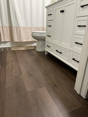 North Ridgeville Flooring Job 2023 - This flooring job was rather large and extensive, I also performed some minor HVAC repairs for the customer and installed a new vanity in each bathroom. I wasn’t able to get before photos with carpet in, I had some over eager assistance on this job. But it was standard white carpet with pet guard carpet padding, along with tack strips and staples, to hold them in place, respectively. Once all the was removed and cleaned out, flooring went down. It was a little tricky, in places but overall I think it turned out  beautifully. Once new floors we in, I installed the flooring in the stairs, and stairnose, I painted shoe molding(quarter round), then installed that vacuumed and swiffered and it was complete.