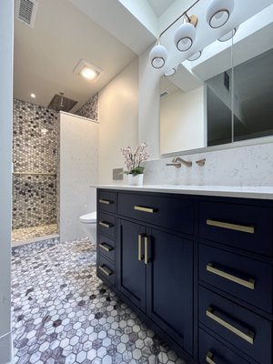 Carmichael - Hex Marble Mosaic Bathroom - We recently completed a delicate and intricate Hexagon Marble mosaic bathroom project. The shower is fully tiled with beautiful mosaic tiles extending seamlessly to the bathroom floor. To complete the look, our customer chose a statement bold dark blue cabinet, adding a striking contrast and a touch of elegance to the space. Contact us for your next remodeling project and let us bring your vision to life. Carmichael - Hex Marble Mosaic Bathroom - We recently completed a delicate and intricate Hexagon Marble mosaic bathroom project. The shower is fully tiled with beautiful mosaic tiles extending seamlessly to the bathroom floor. To complete the look, our customer chose a statement bold dark blue cabinet, adding a striking contrast and a touch of elegance to the space. Contact us for your next remodeling project and let us bring your vision to life.
