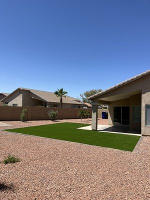 From jungle to beautiful backyard - This backyard went from jungle to a beautiful clean landscape. We installed a beautiful L shape artificial grass area with a paver boarder, 22 tons of rock, pvc irrigation and a large variety of plants and trees.