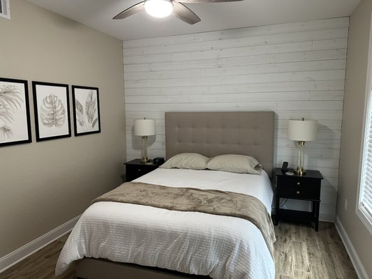Bedroom Remodel - Installed a shiplap accent wall, removed the unneeded bathroom door, replaced all trim, installed new ceiling fan, and painted the room.