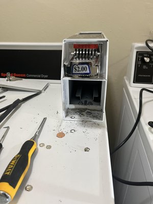 Speed Queen Dryer Coins Box - The customer reported an issue with their Speed Queen dryer, specifically that the coin box was damaged and needed repair. We carefully drilled out the coin box to remove the damaged components and replaced it with a new, functional coin box. After completing the repair, the dryer is now fully operational, and the coin system is working properly. Speed Queen Dryer Coins Box - The customer reported an issue with their Speed Queen dryer, specifically that the coin box was damaged and needed repair. We carefully drilled out the coin box to remove the damaged components and replaced it with a new, functional coin box. After completing the repair, the dryer is now fully operational, and the coin system is working properly.