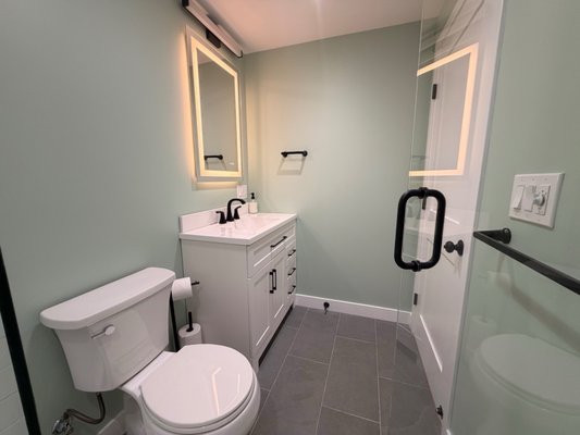 Basement Remodel - This basement was transformed into a clean, comfortable, fully finished living space designed for everyday use and long-term durability.
The project included new flooring, recessed lighting, finished walls and ceilings, custom trim, updated doors, a renovated bathroom with a tiled walk-in shower, improved stairway finishes with integrated lighting, and dedicated utility/storage areas.
The finished basement now provides a bright, modern family room with additional usable space while keeping the mechanical areas organized and accessible.
At All Pro Basement Waterproofing & Remodeling, we handle basement projects from moisture protection and waterproofing through the complete finished remodel.
