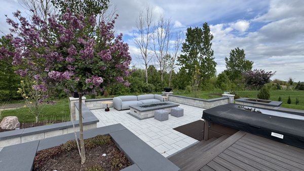 Luxury Outdoor Living Space | New Construction Hardscape Project - Luxury Outdoor Living Space | New Construction Hardscape Project
This custom outdoor living space was designed and built as part of a new home construction project. Because the home was newly built, extensive grading, elevation planning, and compaction were required to ensure long-term stability and proper drainage.
The project features a large paver patio, custom seat walls, raised planter walls, architectural pillars, premium coping, and a modern gas fire feature. Special attention was given to maintaining symmetry with the existing deck and home architecture, requiring precise measurements and elevation calculations throughout the installation.
Every detail was carefully planned to create a functional and beautiful outdoor space that seamlessly blends with the home’s design while providing the perfect setting for relaxation and entertaining.
Mission Brick Paving
Creating Your Perfect Outdoor Oasis
Keywords: Luxury Outdoor Living, Paver Patio, Seat Walls, Retaining Walls, Fire Feature, Hardscape Design, New Construction Patio, Outdoor Living Space, Custom Patio Builder, Naperville, Illinois. Luxury Outdoor Living Space | New Construction Hardscape Project - Luxury Outdoor Living Space | New Construction Hardscape Project
This custom outdoor living space was designed and built as part of a new home construction project. Because the home was newly built, extensive grading, elevation planning, and compaction were required to ensure long-term stability and proper drainage.
The project features a large paver patio, custom seat walls, raised planter walls, architectural pillars, premium coping, and a modern gas fire feature. Special attention was given to maintaining symmetry with the existing deck and home architecture, requiring precise measurements and elevation calculations throughout the installation.
Every detail was carefully planned to create a functional and beautiful outdoor space that seamlessly blends with the home’s design while providing the perfect setting for relaxation and entertaining.
Mission Brick Paving
Creating Your Perfect Outdoor Oasis
Keywords: Luxury Outdoor Living, Paver Patio, Seat Walls, Retaining Walls, Fire Feature, Hardscape Design, New Construction Patio, Outdoor Living Space, Custom Patio Builder, Naperville, Illinois.