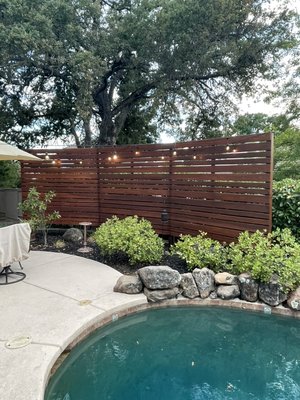 Privacy screen fence refinish - This once beautiful redwood fence was dilapidated and serious need of some N Style Love. We sanded the entire fence to bare wood, the apply a chlorine based brightener to revive the tannins deep In the wood. Then we sprayed and back brushed 2 coats of Benjamin Moore Arbor Coat Translucent, the teak color. Back to life now and thriving! Privacy screen fence refinish - This once beautiful redwood fence was dilapidated and serious need of some N Style Love. We sanded the entire fence to bare wood, the apply a chlorine based brightener to revive the tannins deep In the wood. Then we sprayed and back brushed 2 coats of Benjamin Moore Arbor Coat Translucent, the teak color. Back to life now and thriving!
