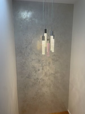 White Venetian Plaster With Gold and Silver Wax - Homeowner wanted to give a luxurious look to this wall with gold and silver wax. To apply Venetian plaster a level 4 or level 5 skim coat is required to get rid off any imperfections on wall. We skim coat the whole wall, primed wall with quartz primer that helps the Venetian plaster to adhere to the wall, three coats of white Venetian plaster and gold and silver wax as a finish coat, buff the wall to give a mirror and smooth look.