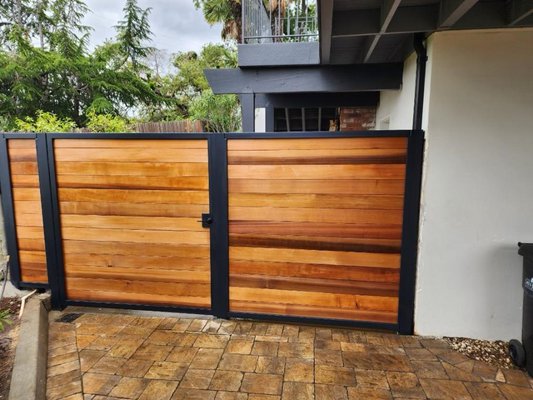 Custom Wood & Steel Gate Installation - Designed and installed custom gates featuring premium wood panels with a sleek steel frame. Built for durability, privacy, and a modern look, enhancing both security and curb appeal. Custom Wood & Steel Gate Installation - Designed and installed custom gates featuring premium wood panels with a sleek steel frame. Built for durability, privacy, and a modern look, enhancing both security and curb appeal.