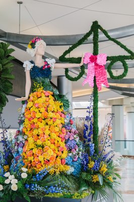 South Coast Plaza 2023 Fleurs De Villes show - We had the distinct pleasure of participating in the 2023 Fleurs De Villes show at South Coast Plaza. This prestigious event selected more than 15 of Southern California's favorite florists to dress mannequins in flowers, each representing a different country's culture. We are deeply honored to be part of this esteemed organization.
Our team was assigned the theme of Swedish Cultural Heritage, with the task of bringing the Midsummer Festival to life at South Coast Plaza. This project was immensely enjoyable for us, and we hope that our valued Yelp customers had the opportunity to stop by and experience it.
The centerpiece of our display was a stunning Swedish-inspired mannequin designed by Ivory Florist, intended to transport viewers to a traditional Midsummer Festival. One of the most iconic symbols of this celebration is the maypole—a tall wooden pole adorned with vibrant flowers and lush greenery. Complementing this, our mannequin featured Swedish women wearing fresh floral headpieces, capturing the essence of the festival's joyful and colorful atmosphere. South Coast Plaza 2023 Fleurs De Villes show - We had the distinct pleasure of participating in the 2023 Fleurs De Villes show at South Coast Plaza. This prestigious event selected more than 15 of Southern California's favorite florists to dress mannequins in flowers, each representing a different country's culture. We are deeply honored to be part of this esteemed organization.
Our team was assigned the theme of Swedish Cultural Heritage, with the task of bringing the Midsummer Festival to life at South Coast Plaza. This project was immensely enjoyable for us, and we hope that our valued Yelp customers had the opportunity to stop by and experience it.
The centerpiece of our display was a stunning Swedish-inspired mannequin designed by Ivory Florist, intended to transport viewers to a traditional Midsummer Festival. One of the most iconic symbols of this celebration is the maypole—a tall wooden pole adorned with vibrant flowers and lush greenery. Complementing this, our mannequin featured Swedish women wearing fresh floral headpieces, capturing the essence of the festival's joyful and colorful atmosphere.