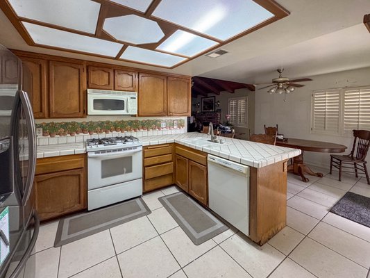 Full Kitchen Remodeling – Chino, CA

📍 11930 Orgren Ave, Chino, CA 91710 - This kitchen was extremely outdated, featuring a dropped ceiling that was approximately 4 inches lower than the original ceiling height, old light fixtures, and tile flooring throughout.

We completed a full kitchen demolition, including the removal of the existing cabinets, countertops, tile flooring, and dropped ceiling. Our team transformed the space into a modern and functional kitchen with brand-new custom cabinetry, new countertops, updated lighting, and electrical work completed according to current code requirements.

In addition to the kitchen remodel, we installed new flooring throughout the entire home, creating a clean and seamless look from room to room.

The entire project was completed within 30 working days, including all required inspections.

Another successful transformation by Together Is Better Design & Build.
