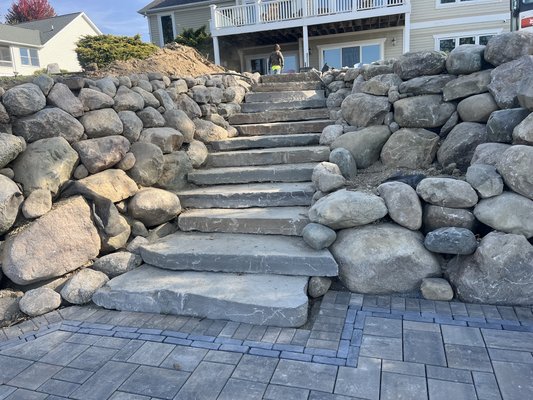 Lakefront Patio - Natural stone steps -Boulder walls - Hardscape renovations over 35 natural limestone steps installed, 1500sqft of patio and 30 tons of boulders for retaining walls Lakefront Patio - Natural stone steps -Boulder walls - Hardscape renovations over 35 natural limestone steps installed, 1500sqft of patio and 30 tons of boulders for retaining walls