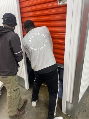 Loading Storage Units - A few members of our crew working hard to pack up storage units for our customers. The worker wrap, load, and stage items into the truck to be tightly packed into the units.