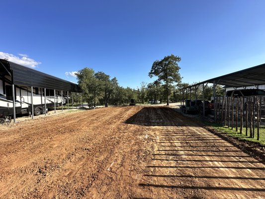 Shop pad - This client wanted a shop pad nestled between his camper port and house. He received several quotes proposing results that go against our clients wishes at very high prices.
We came in and turned our clients vision into reality at a fraction of the price! Here’s how:
After working closely with our client to establish a precise location, drainage, orientation and elevation of their future shop we had 811 locate the property. we then began selectively clearing the pad site and drainage areas based on our clients specifications. The spoils were stockpiled out of the way for later disposal at the customers request.
After the clearing was done it came time to cut the high end of the pad by 3 feet and using the material fill and balance out the pad.
Once we had a rough elevation and envelope for our pad we began to cut our swales. Because of the harsh slope behind the shop we had to get creative to make sure the swales properly divert water away from the structure. We achieved this by creating a small swale immediately behind the structure to drain roof runoff. We then cut in a larger swale further up the hill and used the spoils to build a berm. We did this to ensure that the pace of water in a heavy rain is not fast enough to go over the first swale and berm. All of this water, which previously ran onto the pad site is now diverted directly to the property.
With our flow established we then fine graded the pad to within .05’+\-.
Don’t settle for “some guy with a tractor’s” vision of your project. Give us a call and we will cater to your vision and ensure you get the product you deserve. Shop pad - This client wanted a shop pad nestled between his camper port and house. He received several quotes proposing results that go against our clients wishes at very high prices.
We came in and turned our clients vision into reality at a fraction of the price! Here’s how:
After working closely with our client to establish a precise location, drainage, orientation and elevation of their future shop we had 811 locate the property. we then began selectively clearing the pad site and drainage areas based on our clients specifications. The spoils were stockpiled out of the way for later disposal at the customers request.
After the clearing was done it came time to cut the high end of the pad by 3 feet and using the material fill and balance out the pad.
Once we had a rough elevation and envelope for our pad we began to cut our swales. Because of the harsh slope behind the shop we had to get creative to make sure the swales properly divert water away from the structure. We achieved this by creating a small swale immediately behind the structure to drain roof runoff. We then cut in a larger swale further up the hill and used the spoils to build a berm. We did this to ensure that the pace of water in a heavy rain is not fast enough to go over the first swale and berm. All of this water, which previously ran onto the pad site is now diverted directly to the property.
With our flow established we then fine graded the pad to within .05’+\-.
Don’t settle for “some guy with a tractor’s” vision of your project. Give us a call and we will cater to your vision and ensure you get the product you deserve.