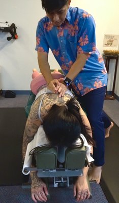 Honolulu Chiropractor, Dr. Wyland Luke helping patients with headaches, neck pain, sciatica and more. Chiropractor for University of Hawaii - Dr. Wyland working on patients and helping them achieve health goals and getting them back to their 100%