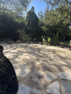 Stone Patio & Xeriscape in Circle C - We demoed a water feature and DIY patio to install this 4 inch concrete topped stones patio and xeriscape to complement the rose garden
