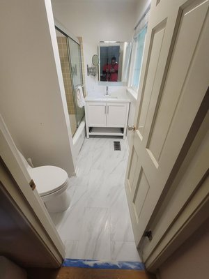 Bathroom remodel - This was a quick remodel, customer wanted a new vanity, switch the old vinyl flooring for tile, and adding a new light and fan unit, and new toilet.