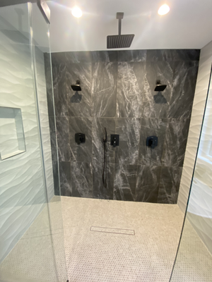 Shower done for a couple late 2023 - The new construction of a house for a freshly married couple had began, but it was just missing something. The young couple wanted a shower they could both share together. After thought process and understanding the couples needs and wants we could translate that exactly to a shower they could now enjoy together. In the picture you can see two shower heads, a body spray, and a rainfall ceiling mounted shower head. Shower done for a couple late 2023 - The new construction of a house for a freshly married couple had began, but it was just missing something. The young couple wanted a shower they could both share together. After thought process and understanding the couples needs and wants we could translate that exactly to a shower they could now enjoy together. In the picture you can see two shower heads, a body spray, and a rainfall ceiling mounted shower head.