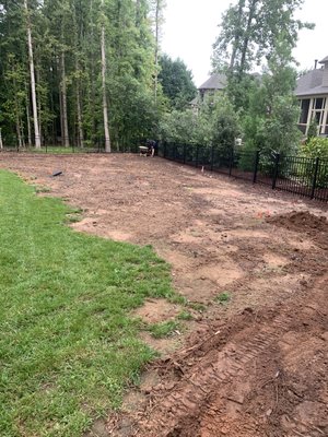 Backyard Transformation - This amazing customer had a terribly washed out yard and could not get grass to grow. Now with a new drainage system made from beautiful rock, fantastic berm made with fresh soil and mulch, and a brand new topsoil backyard freshly aerated will have this backyard looking sharp very soon🏡