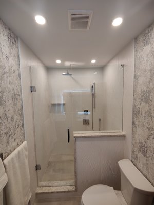 Pelley Shower Remodel - The Pelley's called us with an empty hole in their bathroom. They had done the demo for us. We rerouted the plumbing, built a half wall, installed a full Wedi system with linear drain, repaired all the drywall, built the shower and had our glass specialists come put the finishing touches on!

The Pelley's loved it. Wait until you see their master. We get to do that this spring!