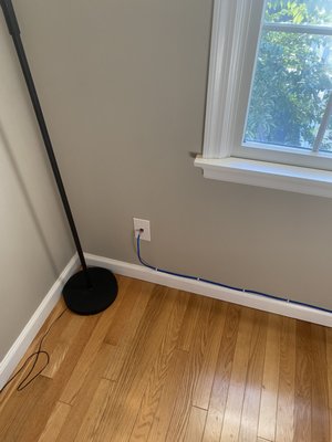 Home Office Network Port & Cabling Installation - We transformed a client's network setup by replacing a long cable that ran on the floor through their home. We installed a network port on the first floor, directly connecting it to another newly installed port in their upstairs office. We ensured a clean, professional installation that significantly enhanced network speed and reliability for his home office.