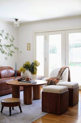 Highlands family room - This small family room design made it a cozy intimate gathering space. We chose a large brown leather recliner to fill the room and surrounded it with mixed seating to encourage conversations. A large round coffee table adds structural interest and provides a large surface for grazing boards, drinks and candles. Vintage elements like the throw, artwork and candleholder keeps the space looking curated and interesting.