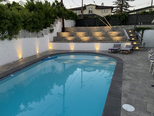 Backyard Pool Renovation with Pavers, Lighting, and Custom Putting Green - This backyard was transformed with new pavers, ambient lighting, and a custom putting green. The upgraded pool area and tiered design add both style and functionality, perfect for relaxing or entertaining. Backyard Pool Renovation with Pavers, Lighting, and Custom Putting Green - This backyard was transformed with new pavers, ambient lighting, and a custom putting green. The upgraded pool area and tiered design add both style and functionality, perfect for relaxing or entertaining.