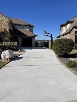 Driveway Resurfacing - Freshly resurfaced driveway featuring a custom concrete overlay in a flagstone pattern. The homeowner selected a warm, natural color palette to complement the home's exterior and enhance curb appeal. This overlay not only adds a stylish, durable finish but also effectively covers existing cracks, giving the driveway a brand-new look Driveway Resurfacing - Freshly resurfaced driveway featuring a custom concrete overlay in a flagstone pattern. The homeowner selected a warm, natural color palette to complement the home's exterior and enhance curb appeal. This overlay not only adds a stylish, durable finish but also effectively covers existing cracks, giving the driveway a brand-new look