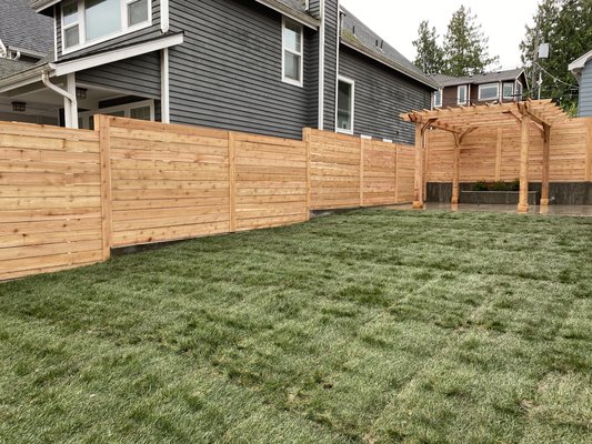 Horizontal Wood Fence Project - We recently completed a beautiful horizontal cedar wood fence in Seattle, showcasing the beauty and craftsmanship of modern outdoor design. Our team worked diligently and efficiently to create a sleek, contemporary fence that blends seamlessly with the surrounding landscape.
The project involved premium wood materials to ensure durability and longevity, while the clean, horizontal lines offer a fresh, stylish aesthetic to any property. This fence design is perfect for homeowners looking for a unique, high-end look that adds both privacy and curb appeal. Horizontal Wood Fence Project - We recently completed a beautiful horizontal cedar wood fence in Seattle, showcasing the beauty and craftsmanship of modern outdoor design. Our team worked diligently and efficiently to create a sleek, contemporary fence that blends seamlessly with the surrounding landscape.
The project involved premium wood materials to ensure durability and longevity, while the clean, horizontal lines offer a fresh, stylish aesthetic to any property. This fence design is perfect for homeowners looking for a unique, high-end look that adds both privacy and curb appeal.