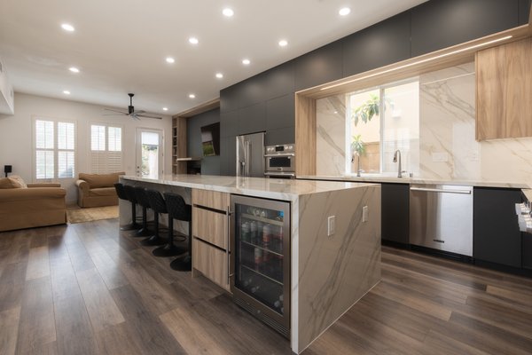 Custom Kitchen Remodel in Irvine - This striking kitchen remodel in Irvine, Orange County is a showcase of custom craftsmanship and contemporary design. 

Built in our state-of-the-art manufacturing facility in North Hills, CA, this project features dramatic matte black cabinetry, natural wood accents, and a showstopping waterfall island in book matched quartz.

Reach out today for your free consultation.