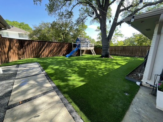 Backyard Turf, Concrete, and Gravel Installation - 2000+ sqft of artificial turf, 3x5 concrete stepping pads, tejas black gravel ribbons. Downspouts buried and drains installed.