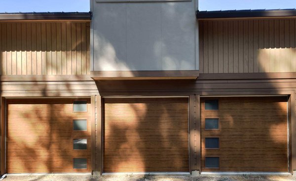 New Install 2019 - New installation of (3) garage doors with Clopay's Ultra-Grain® Cypress Medium Finish color with "vertical lite" glass in the outer doors. New Install 2019 - New installation of (3) garage doors with Clopay's Ultra-Grain® Cypress Medium Finish color with "vertical lite" glass in the outer doors.