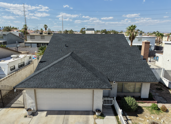 Full Shingle Roof Replacement — Las Vegas - Complete shingle roof replacement on a single-family home in Las Vegas. We tore off the old roof down to the deck, inspected and repaired the decking, installed new synthetic underlayment, and finished with new architectural shingles built to handle the Nevada sun and wind. Clean job site start to finish — the crew left the driveway and yard cleaner than they found it. As a GAF Master Elite contractor, we back our roofs with a 50-year GAF material warranty plus our own Fortitude workmanship warranty. Licensed, bonded, and insured.