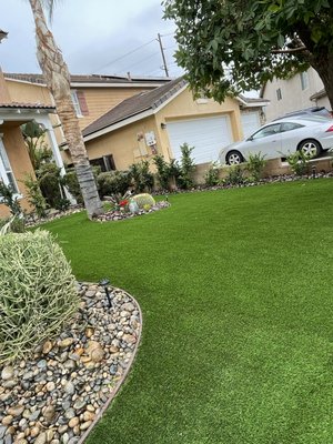 Frontyard Remodel (artificial grass, rocks and trimming tree) - This remodel was done by talking with the client and she wanted more rocks in front of the house . But we gave some other options and opinions and ended changing her mind and we put artificial grass , added river rocks and some plants . Then we added a wet look rocks and it was the outcome and had another satisfied customer Frontyard Remodel (artificial grass, rocks and trimming tree) - This remodel was done by talking with the client and she wanted more rocks in front of the house . But we gave some other options and opinions and ended changing her mind and we put artificial grass , added river rocks and some plants . Then we added a wet look rocks and it was the outcome and had another satisfied customer