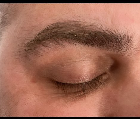 Eyebrow wax before and after - My client came in needing an eyebrow clean up. He had sensitive skin so I used soft wax and buffered the skin with wax oil to lessen the redness and irritation. He was still a little red right after but it subsided in about 10 min. and he was very happy with the result.