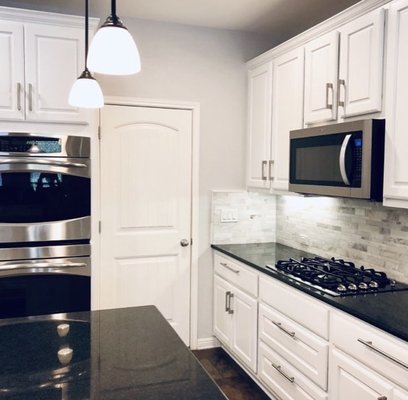 Kitchen Update - In this kitchen we replaced the backsplash, refinished the cabinets, and painted the walls and ceiling. To complement this, we replaced the hanging light fixtures above the island. The end result being an updated and more inviting kitchen. Kitchen Update - In this kitchen we replaced the backsplash, refinished the cabinets, and painted the walls and ceiling. To complement this, we replaced the hanging light fixtures above the island. The end result being an updated and more inviting kitchen.