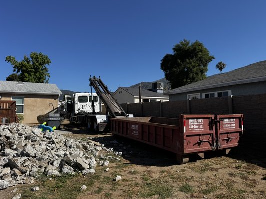 10 Yard Lowboy Dumpster for Dirt & Concrete Removal – Sylmar, CA - This 10-yard lowboy dumpster was delivered for a residential concrete and dirt removal project in Sylmar. Our low-profile bin is specifically designed for heavy materials such as concrete, dirt, brick, asphalt, and rock. The compact size allows easy loading while staying within legal weight limits for safe hauling.
The customer used the bin to remove broken concrete and excavated soil during a property improvement project. Delivery was completed on schedule, and the dumpster was positioned for convenient loading and quick pickup. 10 Yard Lowboy Dumpster for Dirt & Concrete Removal – Sylmar, CA - This 10-yard lowboy dumpster was delivered for a residential concrete and dirt removal project in Sylmar. Our low-profile bin is specifically designed for heavy materials such as concrete, dirt, brick, asphalt, and rock. The compact size allows easy loading while staying within legal weight limits for safe hauling.
The customer used the bin to remove broken concrete and excavated soil during a property improvement project. Delivery was completed on schedule, and the dumpster was positioned for convenient loading and quick pickup.