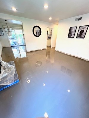 living area upgrade - This upgrade was done on a house with old damage glued down wood floor, We self-leveled the floor, to get a smooth finish to ensure the customer receives the best quality install job. The material used was vinyl plank flooring.
